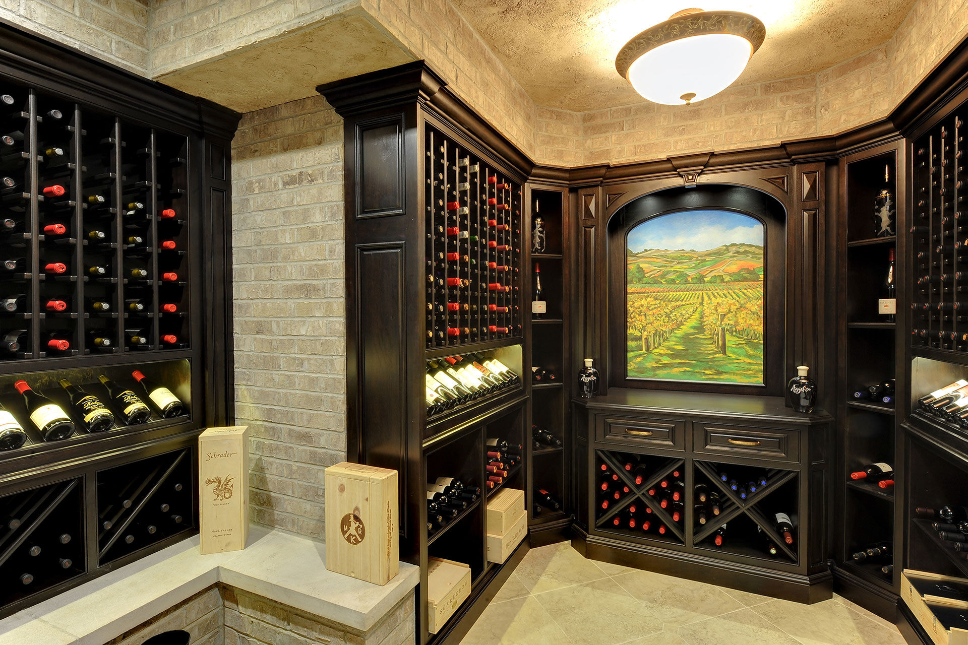 Showpiece custom wine cellar in Midland, TX with walnut millwork, glass, and gallery lighting
